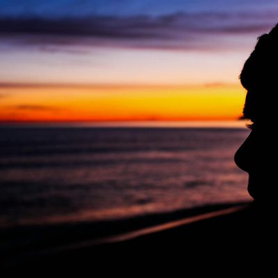Abstract silhouette of a person in a meditative, calm state.
